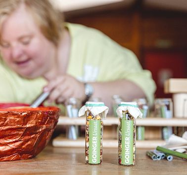 Frau hält Löffel in eine rote Schale