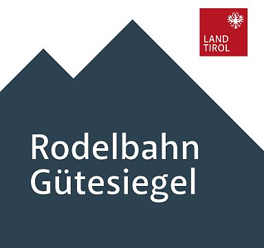 Logo depicting a stylized mountain with the words "Rodelbahn Gütesiegel" and "Land Tirol" badge in the top right corner.
