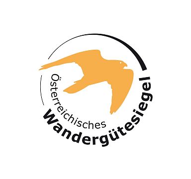Logo of the Austrian Hiking Quality Seal featuring an orange bird silhouette in a circular design.